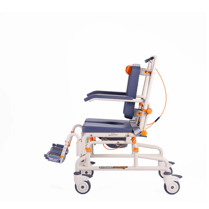 A side view of a medical transport wheelchair with orange and gray accents, featuring armrests, footrests, wheels, and a commode seat—compatible with the ShowerBuddy Petite Buddy P1 Child & Small User Kit for improved mobility.