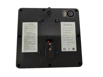 The image shows the back of a ComfyGo Phoenix Carbon Fiber Electric Wheelchair with a sleek finish, featuring informational labels, a small antenna, a USB port, and a connector port. The labels provide product and safety details.
