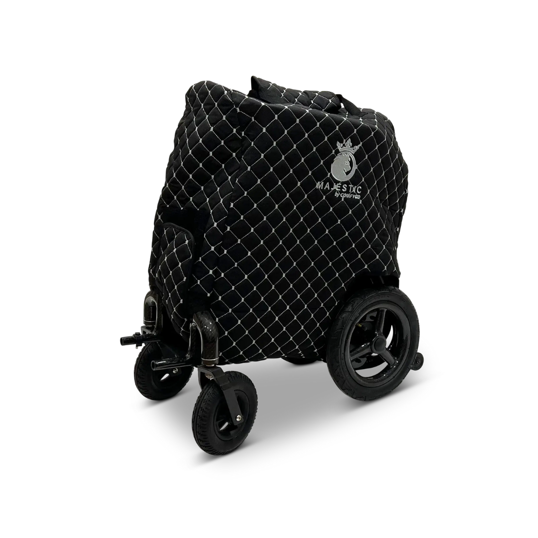 A ComfyGo Phoenix Electric Wheelchair Travel Bag & Protector Set, featuring a quilted black durable canvas cover with a white Majestic logo, is displayed folded against a plain white background.