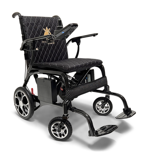 The ComfyGo Phoenix Carbon Fiber Electric Wheelchair features a quilted black seat, armrests, joystick control panel, foldable design with an emblem on the backrest, four wheels, and front-extended carbon fiber footrests.