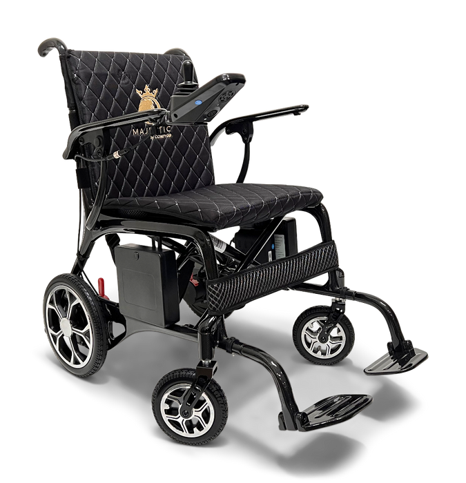 The ComfyGo Phoenix Carbon Fiber Electric Wheelchair features a quilted black seat, armrests, joystick control panel, foldable design with an emblem on the backrest, four wheels, and front-extended carbon fiber footrests.