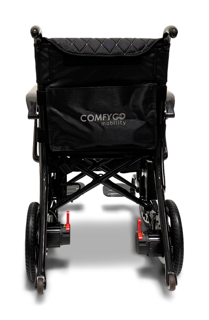 The ComfyGo Phoenix Carbon Fiber Electric Wheelchair features a sleek black design with COMFYGO mobility on the backrest. It boasts a lightweight metal frame, red release levers for compact folding, and modern elegance typical of carbon fiber innovations.