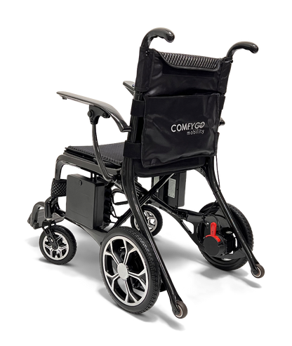 The ComfyGo Phoenix Carbon Fiber Electric Wheelchair is a lightweight, portable option with a black frame and seat. It features small front wheels, larger rear wheels, foldable armrests, and a storage compartment on the backrest. The ComfyGo Mobility brand is subtly displayed.