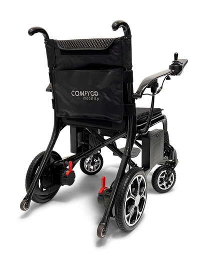 The ComfyGo Phoenix Carbon Fiber Electric Wheelchair, in sleek black with a storage pocket, includes a joystick for control, cushioned seat, and four-wheel build. Its foldable design is highlighted from the back against a white background.