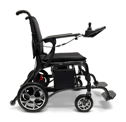 The ComfyGo Phoenix Carbon Fiber Electric Wheelchair boasts a side view showing its sleek design with large rear wheels, smaller front wheels, and armrest joystick control. Its cushioned seat and backrest ensure comfort, while carbon fiber parts enhance durability, set against a plain backdrop.