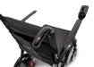 Close-up of the sleek black ComfyGo Phoenix Carbon Fiber Electric Wheelchair, showcasing its fabric seat and backrest. With armrests and a right-side joystick control, it features foldable carbon fiber spokes and displays the COMFY mobility label on the backrest.