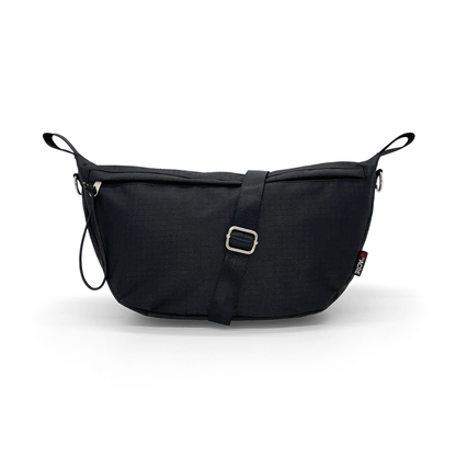 The Pocket Bag for byACRE Carbon Fiber Rollators is a black, rectangular crossbody bag with an adjustable strap, metal buckle, small side loops, and a red-and-white tag for a stylish and practical mobility accessory.