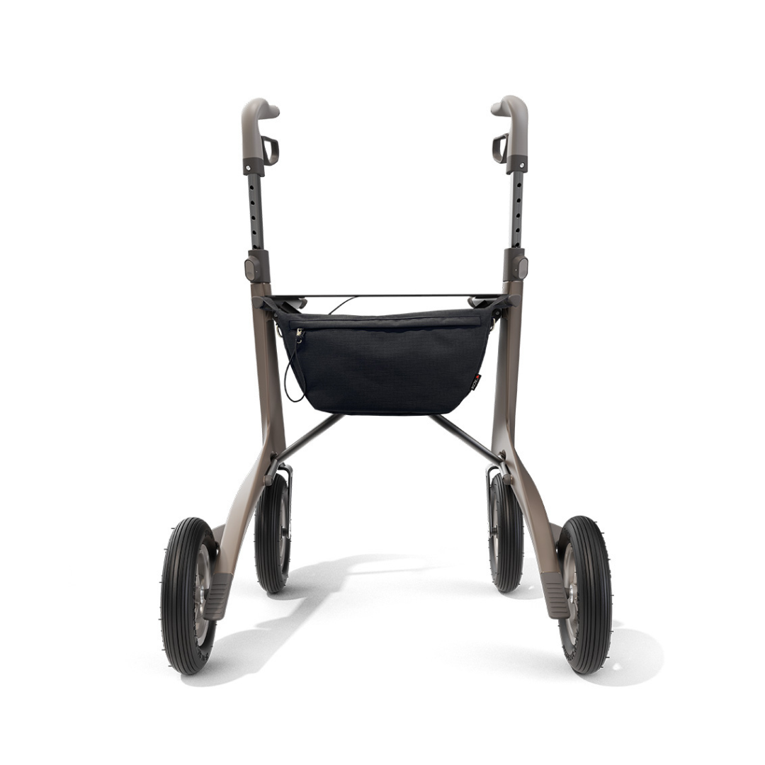 The Pocket Bag for ByAcre Carbon Fiber Rollators, shown from the front against a white background, is a black accessory designed for four-wheeled mobility walkers with large tires and adjustable handles.