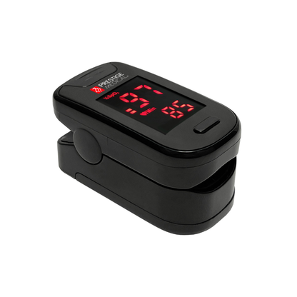 The Prestige Fingertip Pulse Oximeter displays oxygen saturation (97%) and pulse rate (85 bpm) as red LED numbers on a black device, serving as a reliable SpO2 monitor against a white background.