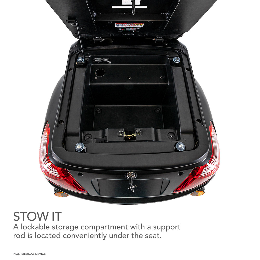 A lockable storage compartment with a support rod is located under the seat of the Pride Baja® Raptor® 2 Bariatric 3-Wheel Scooter, offering convenient stowage with an open lid held up securely. Text: STOW IT.