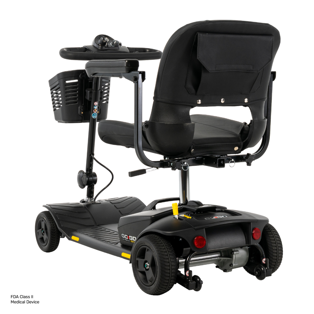 A Pride Go Go® Ultra X Gen 3 Portable Mobility Scooter in black, featuring a front storage basket, padded seat with armrests, and four wheels, shown from the rear right side against a white background.