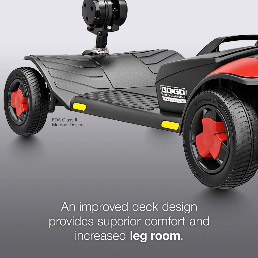 The black textured foot deck of a Pride Go Go® Elite Traveller Gen 3 Platinum Portable Scooter, featuring red wheel accents and text reading FDA Class II Medical Device.