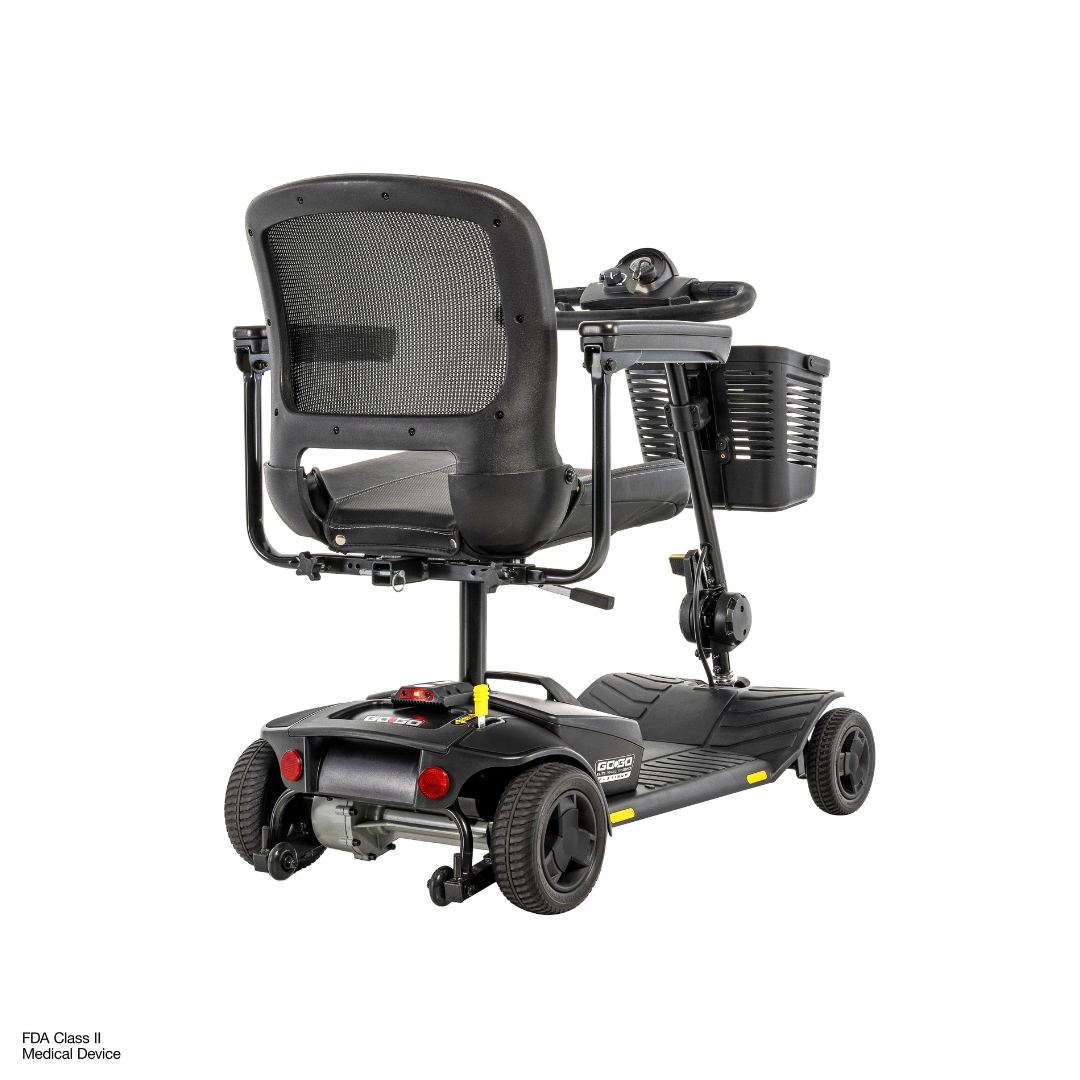 Rear view of a black Pride Go Go® Elite Traveller Gen 3 Platinum Portable Scooter, featuring a mesh backrest, a front-mounted basket, and a black floorboard; see specifications for further details.