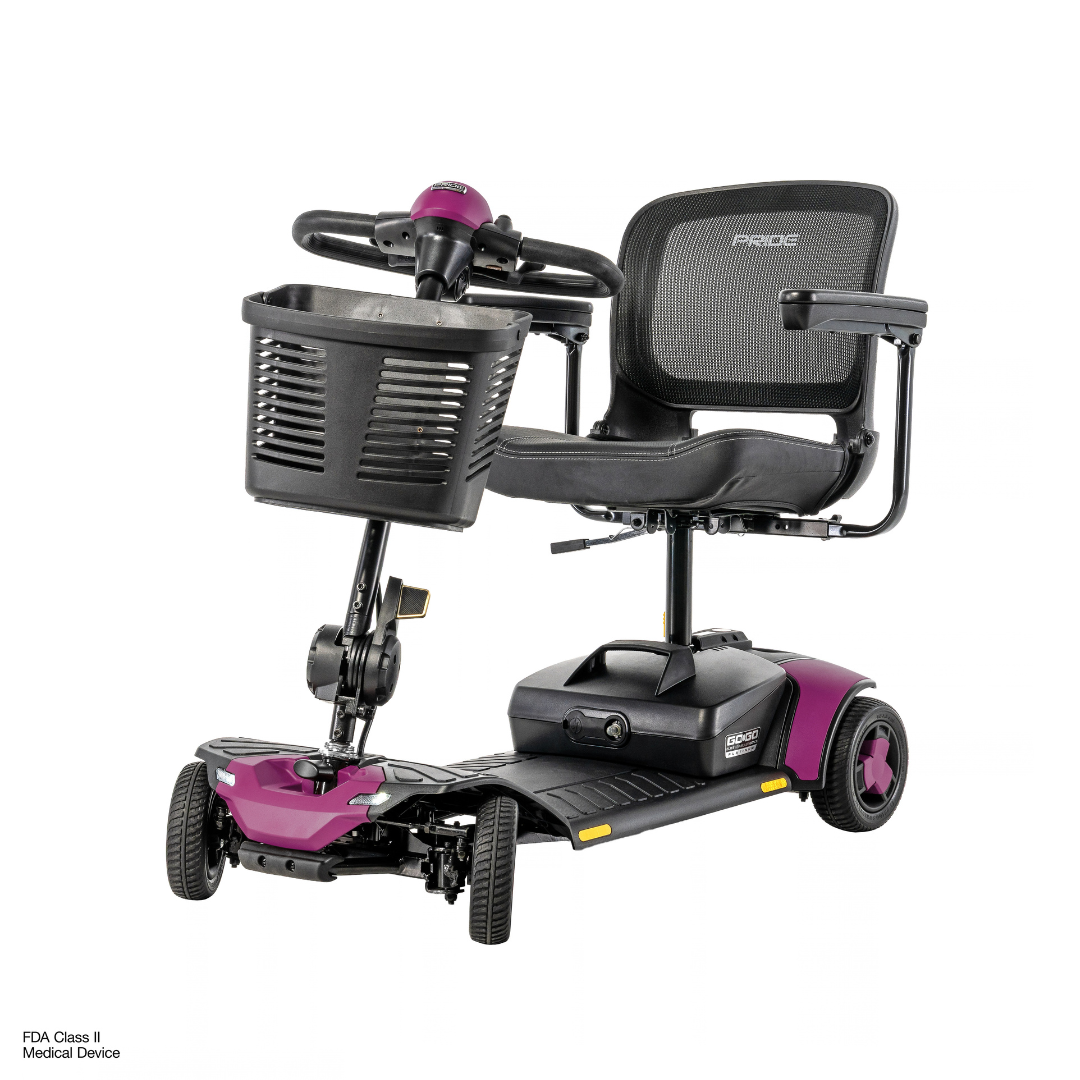 Pride Go Go® Elite Traveller Gen 3 Platinum Portable Scooter, a four-wheeled purple and black mobility scooter with a front basket and a mesh back seat.