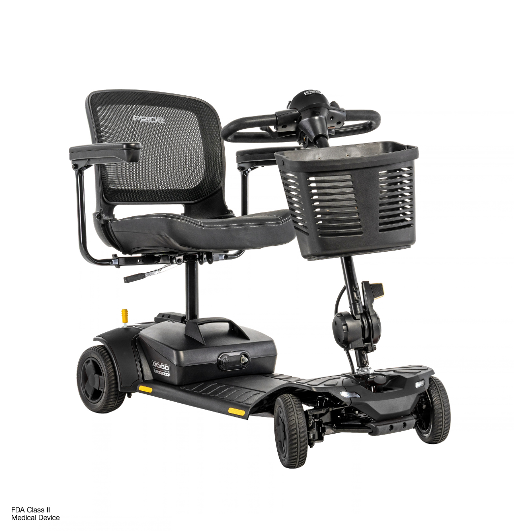 A four-wheeled Pride Go Go® Elite Traveller Gen 3 Platinum Portable Scooter with a black mesh seat, tiller steering, and a front storage basket, shown in product videos.