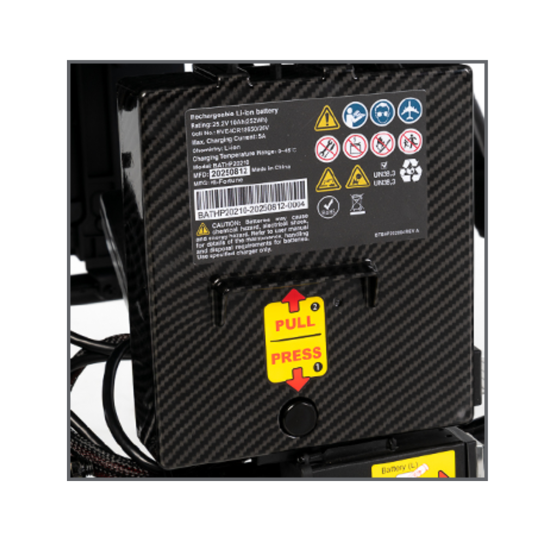 Close-up of a lightweight, black carbon-fiber-textured rechargeable lithium-ion battery pack—an ideal accessory for the Jazzy® Carbon 27X Powerchair, featuring warning labels and yellow PULL/PRESS instructions marked by red arrows.
