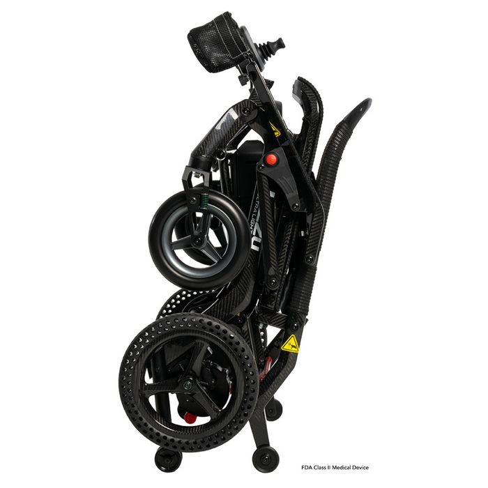 Introducing the Pride Mobility Jazzy® Ultra Light Portable Electric Wheelchair: a sleek, black model with a carbon fiber frame and compact wheels. Its foldable design and ergonomic structure ensure effortless transport and storage, while the visible joystick allows for smooth navigation.