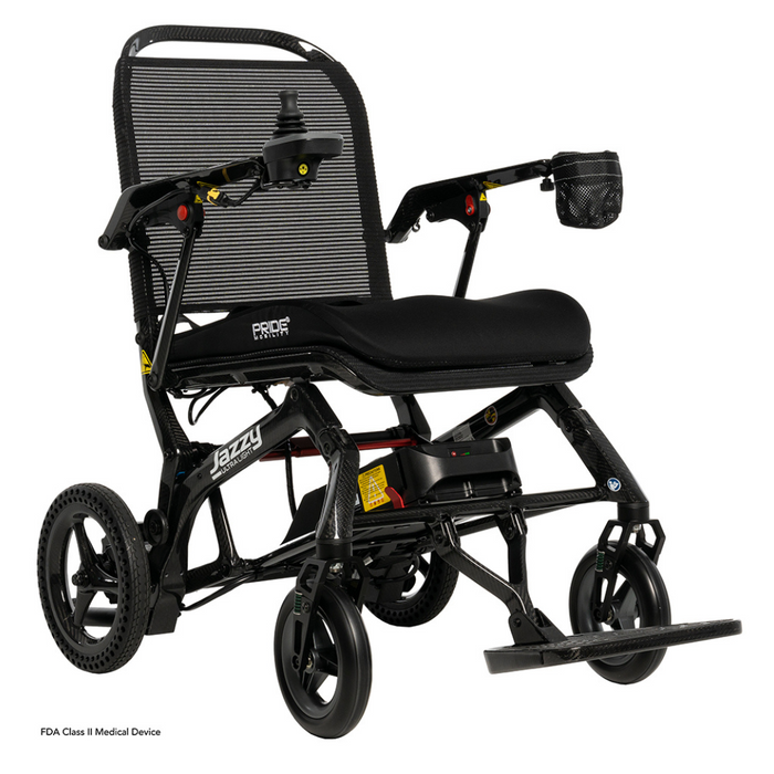 The Pride Mobility Jazzy® Ultra Light Portable Electric Wheelchair is ideal for travel with its mesh backrest, padded seat, joystick control, foldable carbon fiber frame, armrests, and footrest. Designed for easy mobility, this ultra-light wheelchair ensures comfort and convenience on the go.