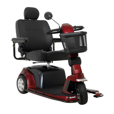 The Pride Mobility Maxima 3-Wheel Bariatric Scooter features a red frame, black cushioned seat with armrests and headrest, handlebar controls, front basket, three wheels, and supports up to 500 lbs for personal transport.