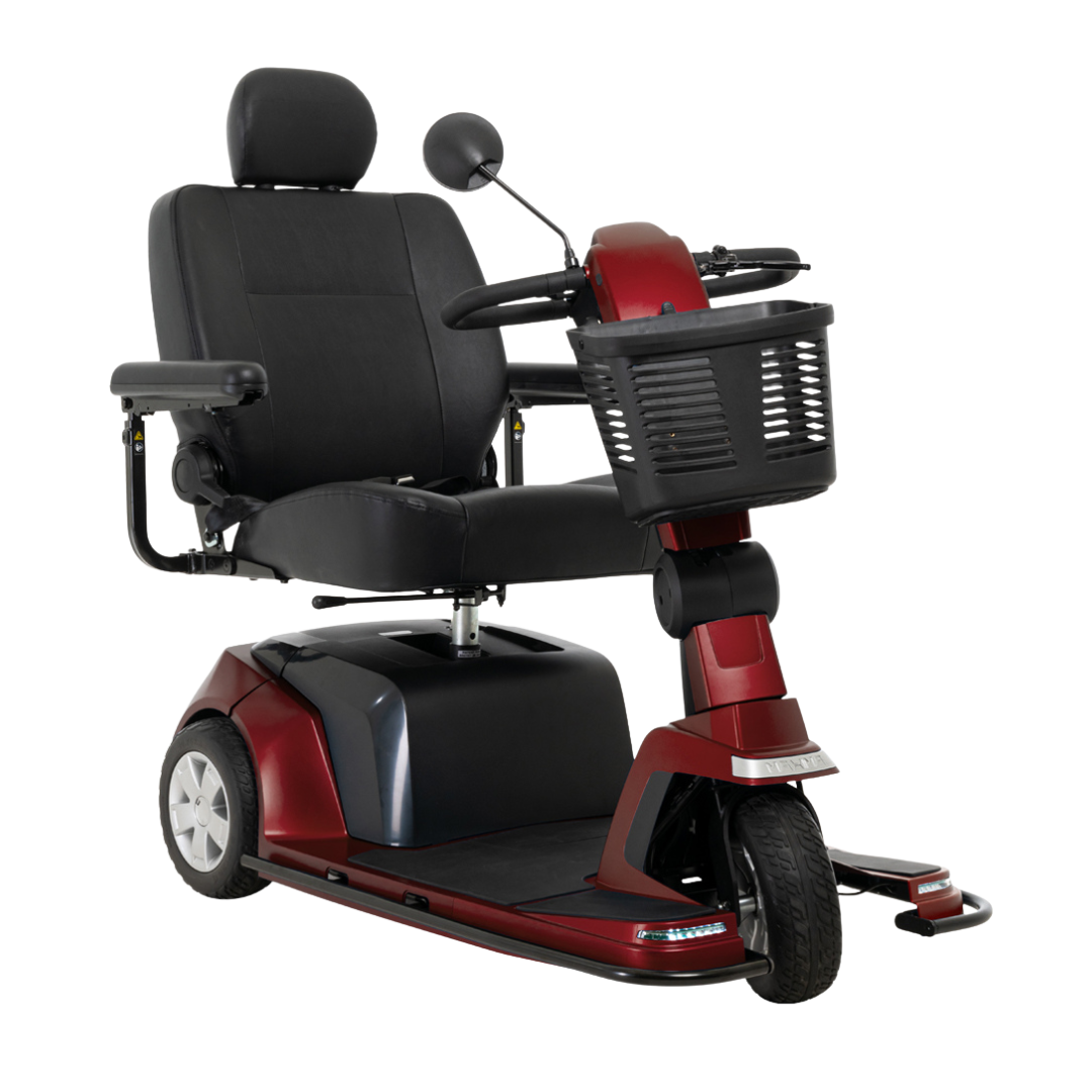 The Pride Mobility Maxima 3-Wheel Bariatric Scooter features a red frame, black cushioned seat with armrests and headrest, handlebar controls, front basket, three wheels, and supports up to 500 lbs for personal transport.