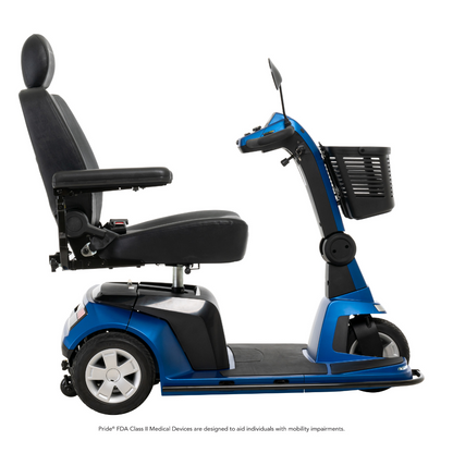 The Pride Mobility Maxima 3-Wheel Bariatric Scooter, shown in blue with a high back seat, armrests, handlebar controls, and front basket, is displayed from the side on a white background and supports up to 500 lbs.