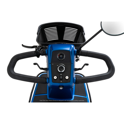 Close-up view of the control panel and handlebars of the Pride Mobility Maxima 3-Wheel Bariatric Scooter, showing a display screen, buttons, and a right-side rearview mirror.