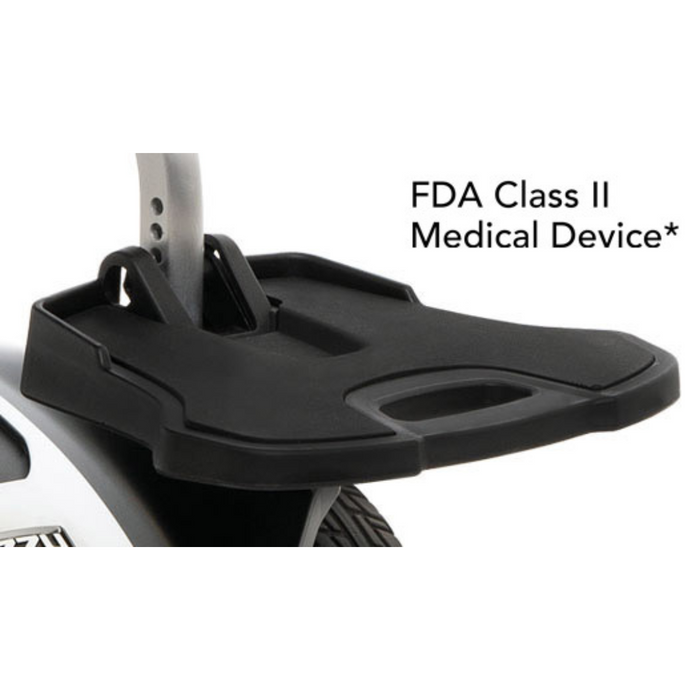 The black footplate attachment for the Pride Mobility Jazzy Air®2 Powerchair provides a flat surface with an edge. Displayed on a white background, it reads FDA Class II Medical Device, ensuring safety and improved mobility.