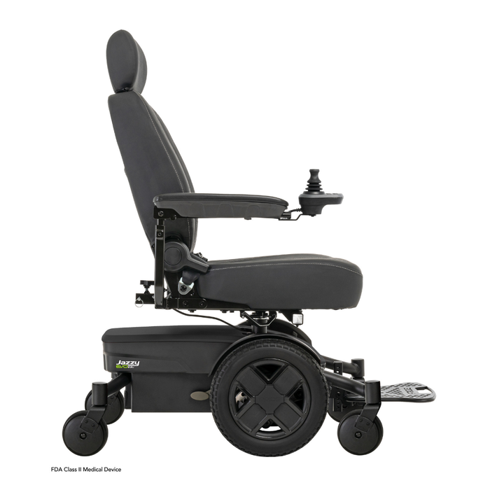 A black Pride Mobility Jazzy® EVO 613 Powerchair with ATX Suspension, cushioned seat, armrests, joystick controller, footrest, and four wheels with Mid-Wheel 6® Technology is shown in side profile on a white background.