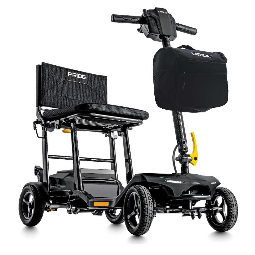 The Pride Mobility Go Go® Super Portable Mobility Scooter is black and yellow, featuring a sturdy frame, four wheels, a comfy seat with backrest, handlebars, and a front storage bag. It includes an airline-approved battery for travel convenience and sports the Pride logo on the seat and bag.