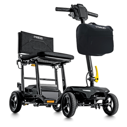 The Pride Mobility Go Go® Super Portable Mobility Scooter is black and yellow, featuring a sturdy frame, four wheels, a comfy seat with backrest, handlebars, and a front storage bag. It includes an airline-approved battery for travel convenience and sports the Pride logo on the seat and bag.