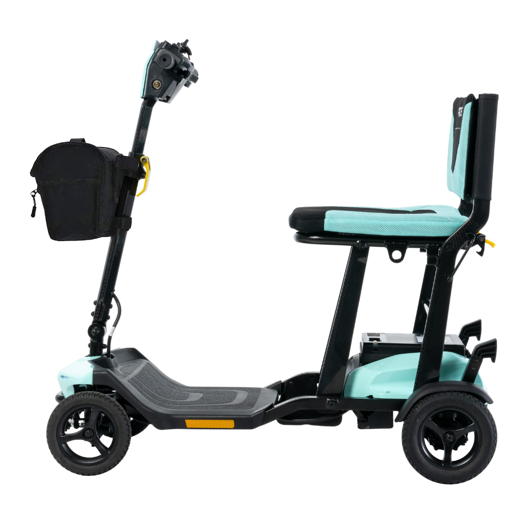 Side view of a Pride Mobility Go Go® Super Portable Scooter in teal and black, featuring three wheels, a cushioned seat, and a handlebar-attached black bag. Its lightweight with an airline-approved battery, sturdy frame, and footrest platform.