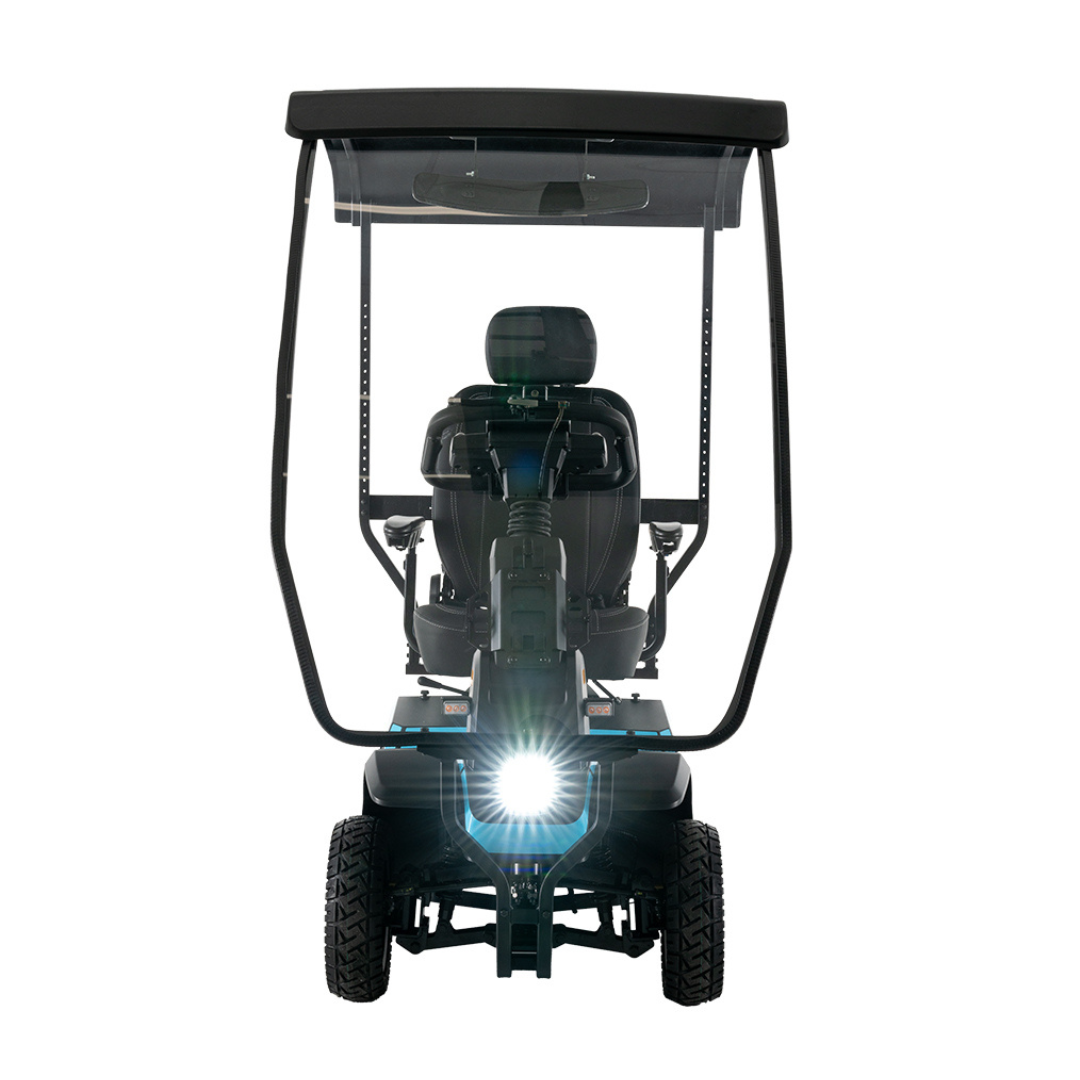 A front view of the Pride Mobility PX4 HD Bariatric Scooter with a canopy, large tires, and its headlight on, photographed against a white background.