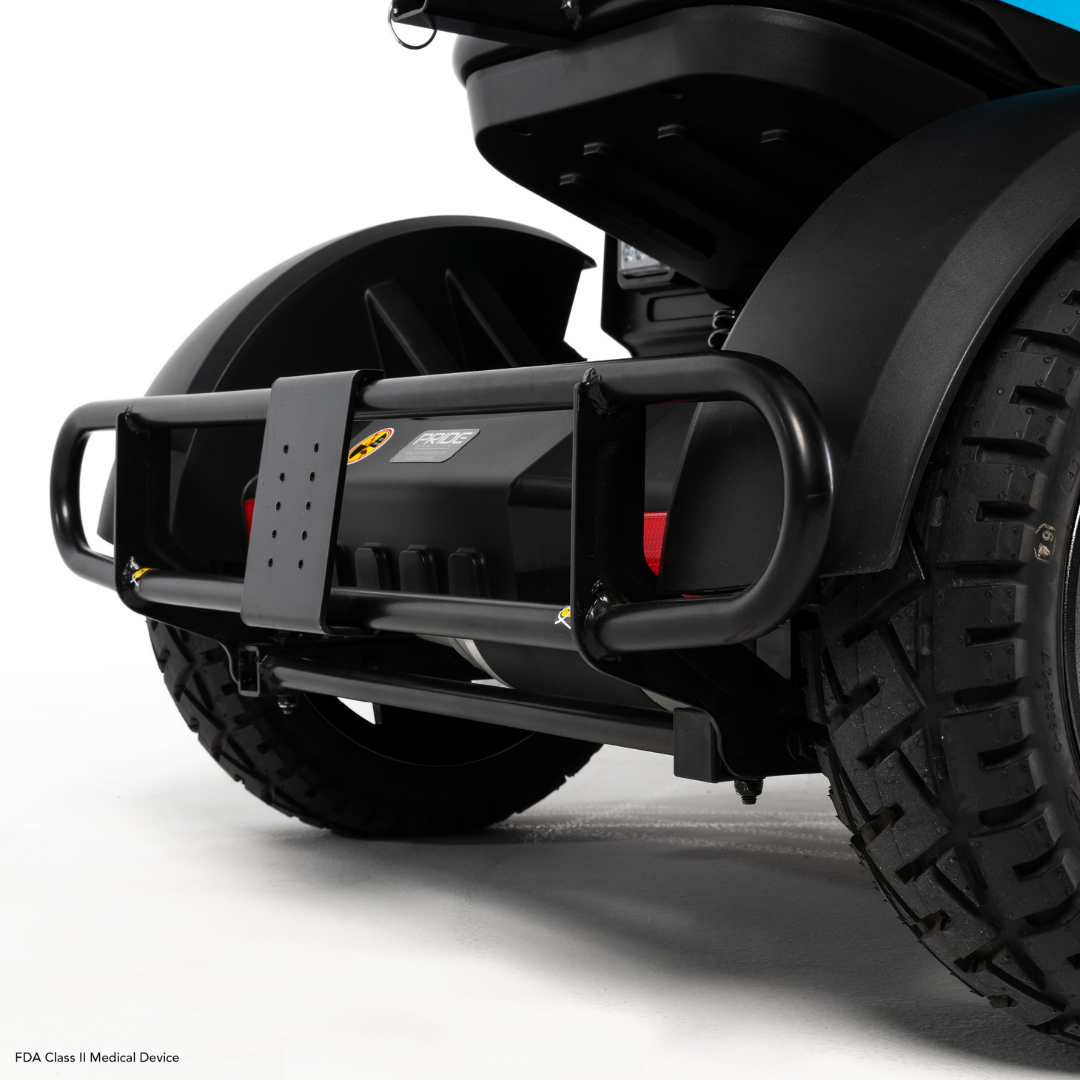 Close-up of the rear bumper and rugged wheel on the Pride Mobility PX4 HD Bariatric Scooter, showcasing its sturdy construction and protective features against a white background.