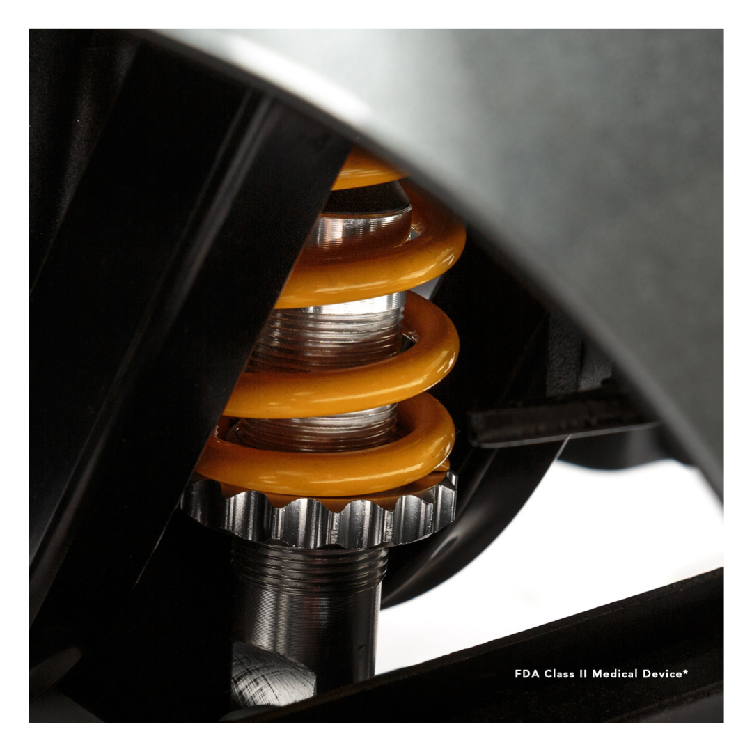 Close-up of an orange coil spring and metal parts on the Pride Mobility Revo® 2.0 4-Wheel Scooter, with "FDA Class II Medical Device*" in the bottom right corner.