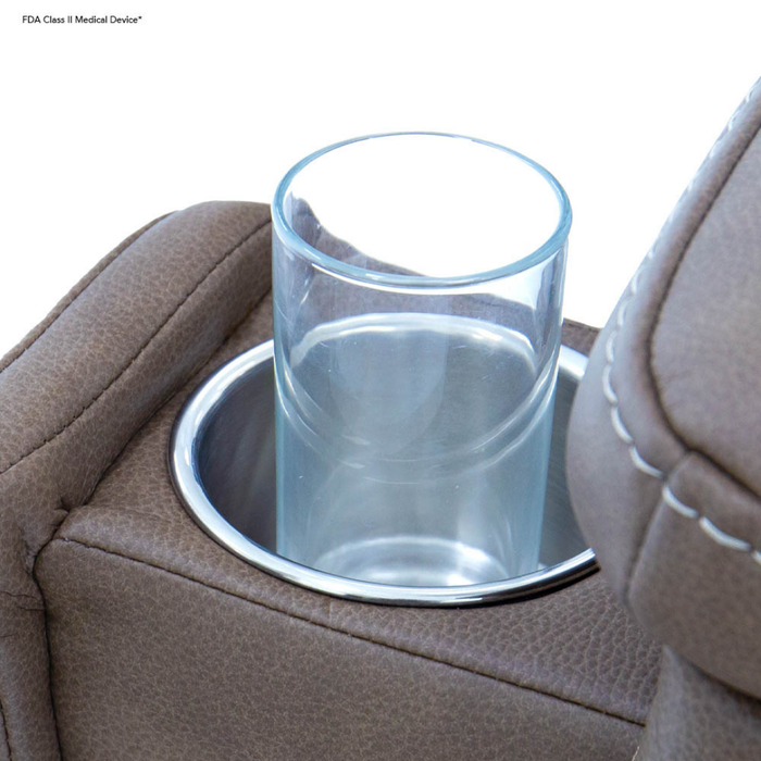A clear glass rests in a metal holder on a brown, leather-textured chair armrest, highlighting the comfort and luxury of the Pride VivaLift Ultra PLR4955 Recliner with Lift Assist, Heat, and Massage.