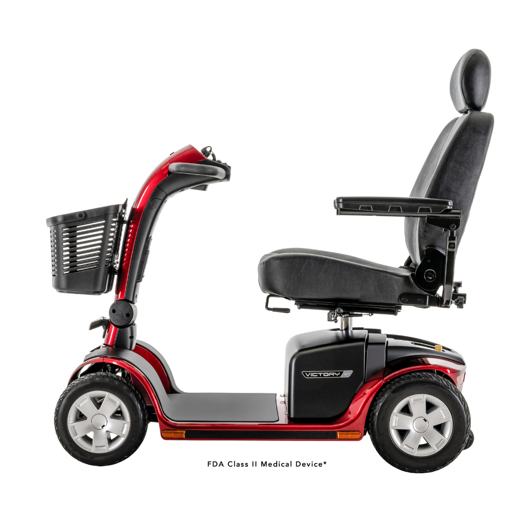 A Pride Mobility Victory® 10 4-Wheel Scooter with EZ Turn, featuring a red and black design, high backrest, armrests, front basket, and four wheels, is shown in profile view on a white background.