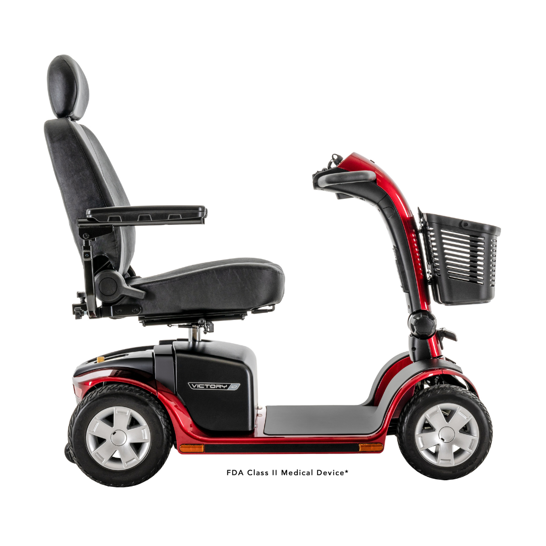 A Pride Mobility Victory® 10 4-Wheel Scooter with EZ Turn in red and black, featuring a cushioned seat, armrests, and a front basket, is displayed from the side on a white background.