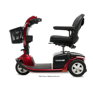 The Pride Mobility Victory® 10.2 Bariatric 3-Wheel Scooter, in red with a black seat, armrests, and front basket, is an FDA Class II Medical Device—shown in profile on white—offering comfort and reliability.