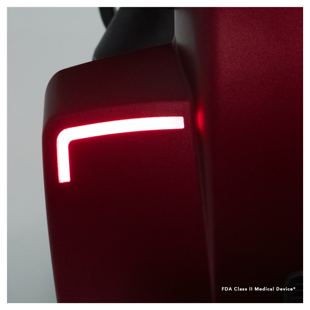 Close-up of the sleek, red Pride Mobility Victory® 10.2 Bariatric 3-Wheel Scooter with a glowing L-shaped LED light. FDA Class II Medical Device*, ideal for those seeking a luxury mobility scooter experience.