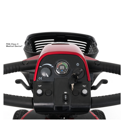 Close-up of the control panel on a Pride Mobility Victory® 10.2 Bariatric 3-Wheel Scooter, featuring handlebars, ignition key, buttons, battery indicator, display, rear black basket, and a medical device label on the left side.