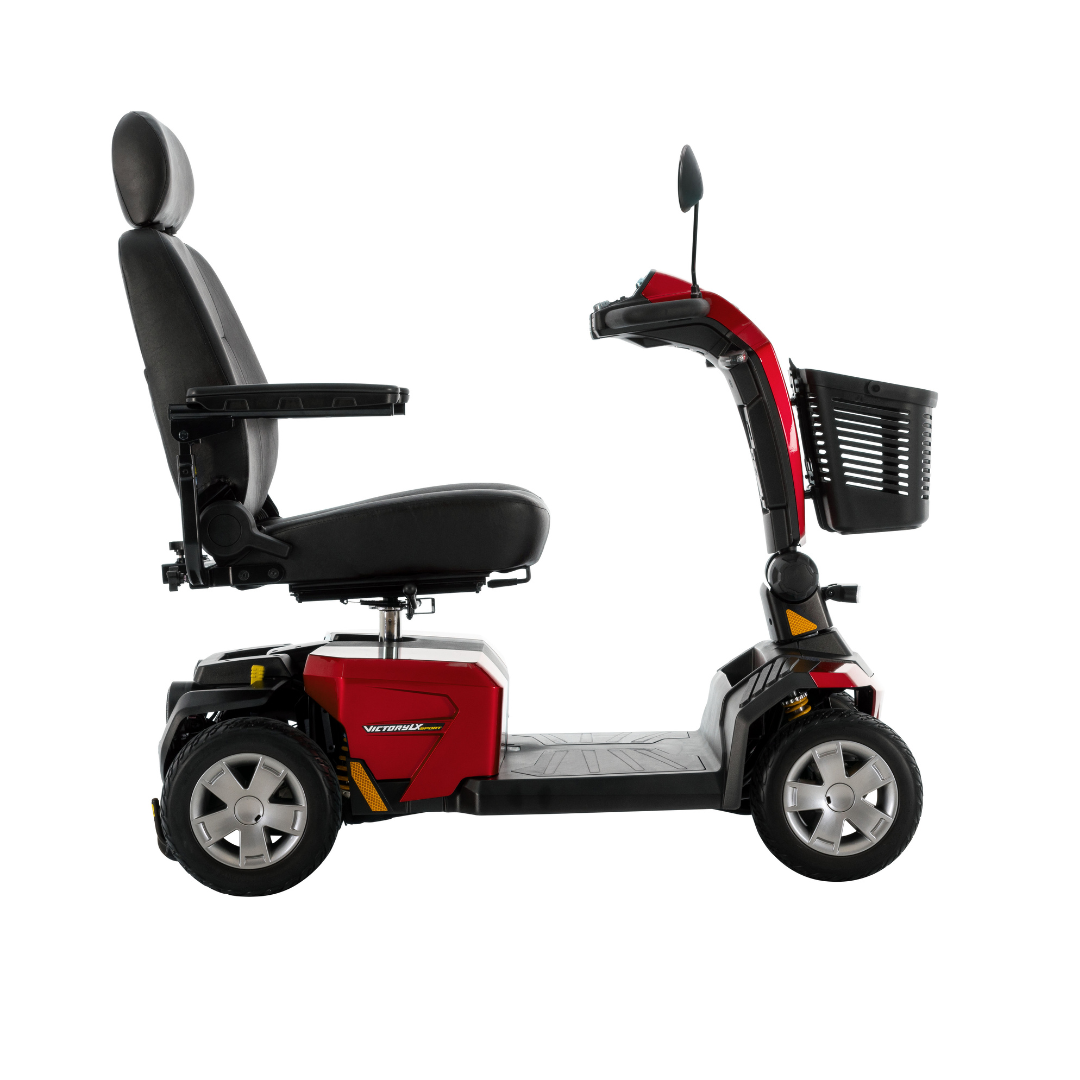 The Pride Mobility Victory LX Sport Scooter in red and black features a high back seat, armrests, rear-view mirror, front basket, and Comfort-Trac Suspension, shown in profile on a white background.