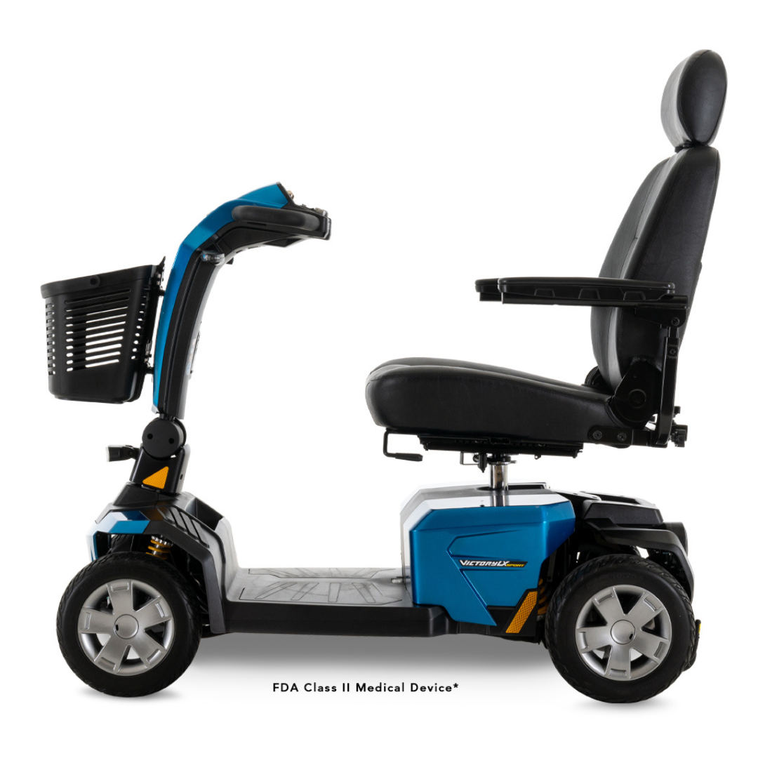 The Pride Mobility Victory LX Sport Scooter, shown from the side against a white background, features four wheels, blue and black design, front basket, padded seat with armrests and headrest, plus Comfort-Trac Suspension.