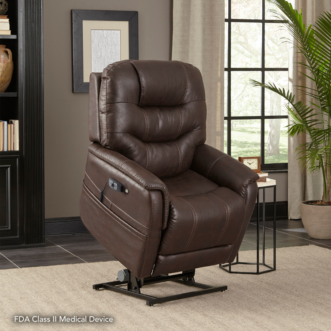 The Pride VivaLift!® Elegance 2 Recliner with Lift Assist, featuring plush dark brown leather and electronic controls, sits on a beige rug in a living room with large windows, a green plant, and shelves for luxurious relaxation.