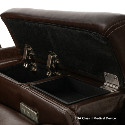 A close-up of an open storage compartment in the armrest of a brown leather Pride VivaLift! Premier Recliner With Assisted Lift, Audio & Massage. The black-lined compartment has metal hinges. "FDA Class II Medical Device" is in the bottom right corner.