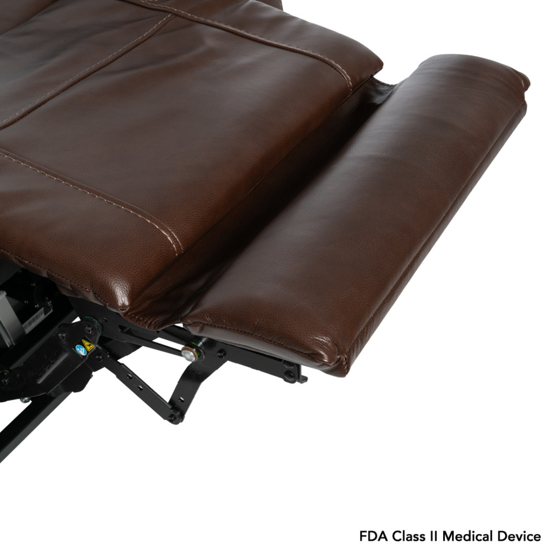A close-up of a brown leather Pride VivaLift! Premier Recliner With Assisted Lift, Audio & Massage with an extended footrest reveals the metal support mechanism. "FDA Class II Medical Device" appears in the bottom right corner.