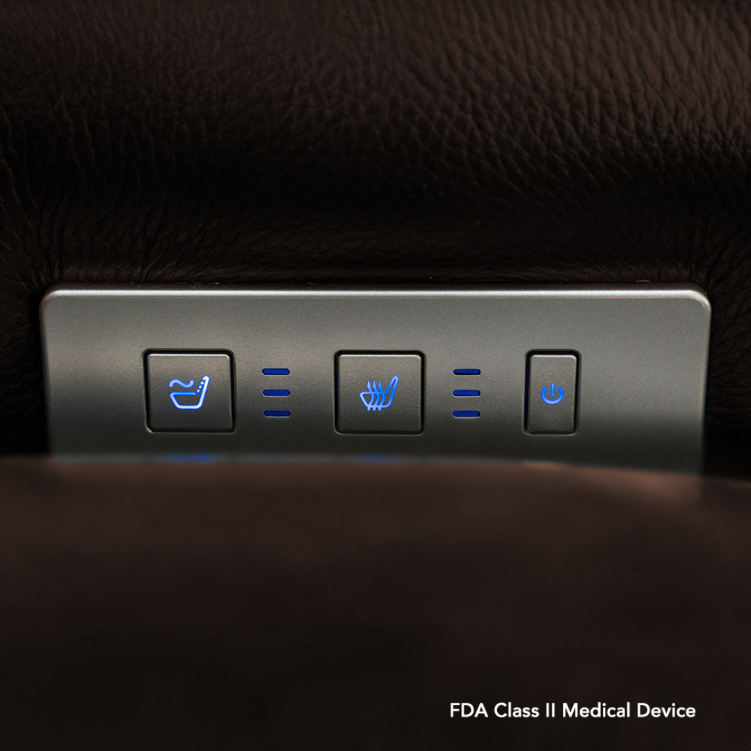 Close-up of the Pride VivaLift! Premier Recliner With Assisted Lift, Audio & Massage control panel showing three illuminated seat adjustment, heating, and power buttons on dark brown leather. FDA Class II Medical Device shown in lower right corner.