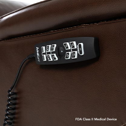 A black remote control with multiple buttons sits on a brown leather surface. "FDA Class II Medical Device" appears in white, emphasizing its compatibility with the Pride VivaLift! Premier Recliner With Assisted Lift, Audio & Massage.