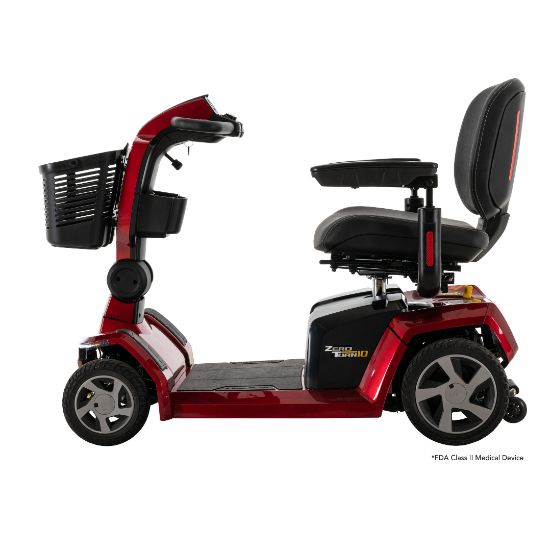A side view of the Pride Mobility Zero Turn 10 HD Scooter in red, featuring EZ Turn Technology, a front basket, padded seat, armrests, and foot platform is displayed against a white background.