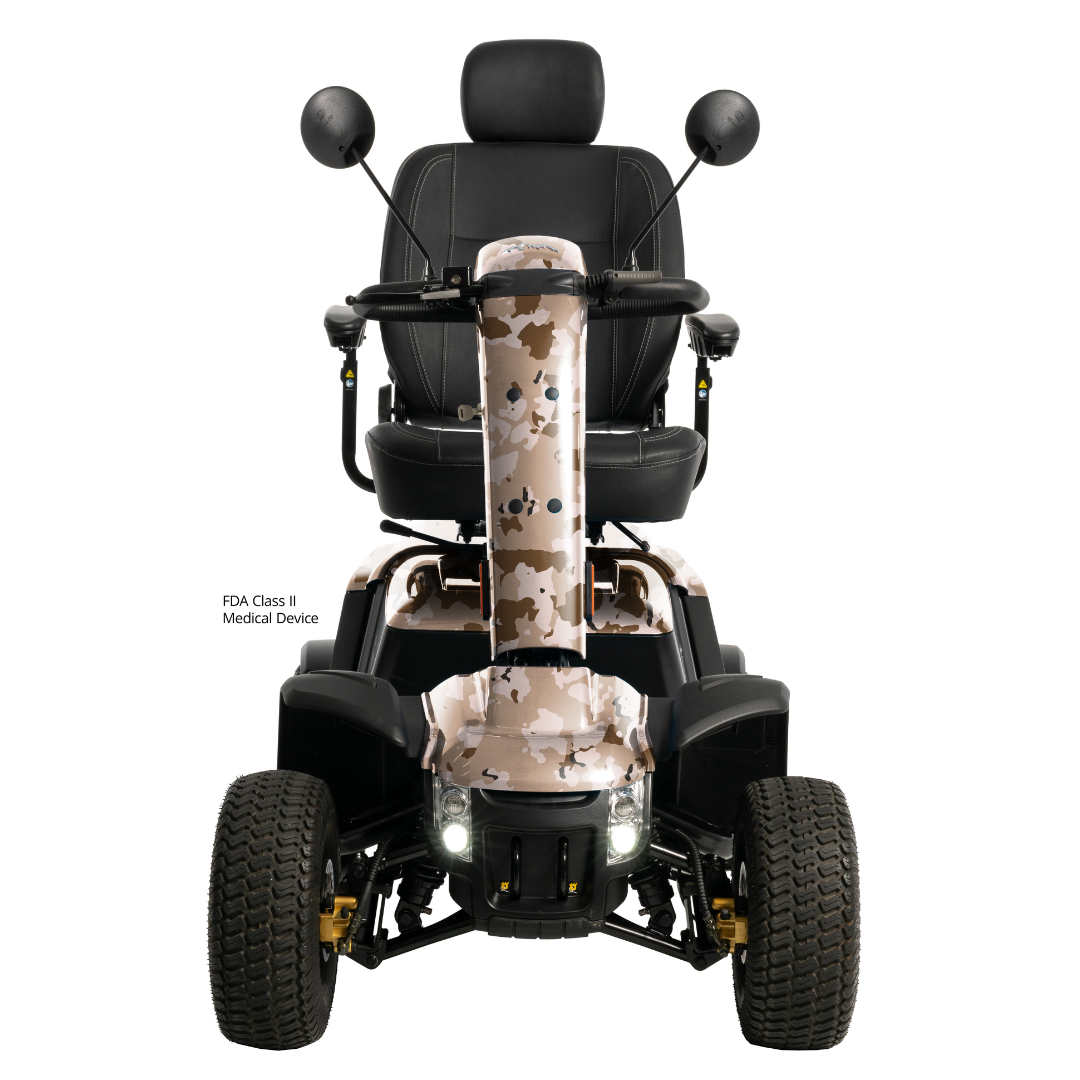 Front view of the Pride Baja® Wrangler® 2 Heavy Duty Outdoor Scooter in camouflage, with large rugged tires, black seat with armrests and headrest, mirrors, headlights, and advanced safety features. FDA Class II Medical Device label shown.
