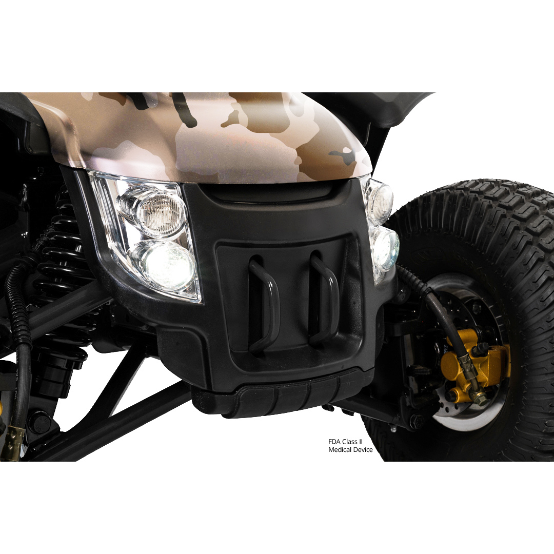 Close-up of the Pride Baja® Wrangler® 2 Heavy Duty Outdoor Scooter with Canopy in camo, showing headlights, suspension, black bumper with two handles, and a large rugged tire featuring visible gold brake components.